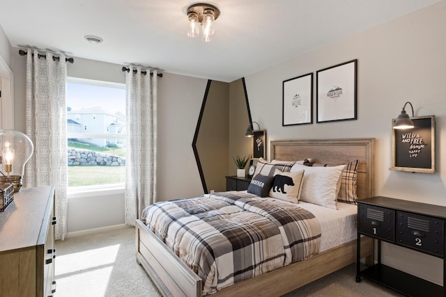 bedroom with carpet floors, multiple windows, and baseboards