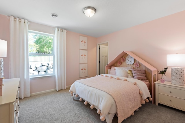 bedroom featuring light carpet and baseboards