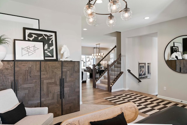 entrance foyer featuring stairs, baseboards, a chandelier, and recessed lighting