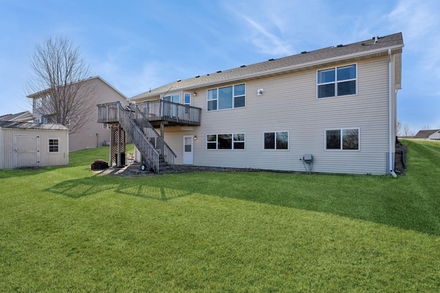 back of property featuring a storage unit, stairway, a yard, an outdoor structure, and a wooden deck