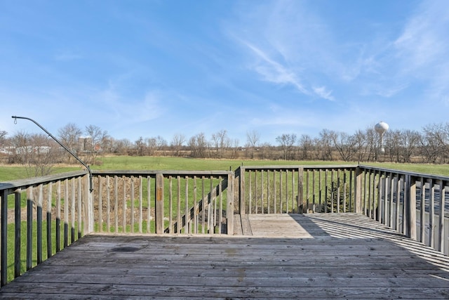 wooden deck with a rural view