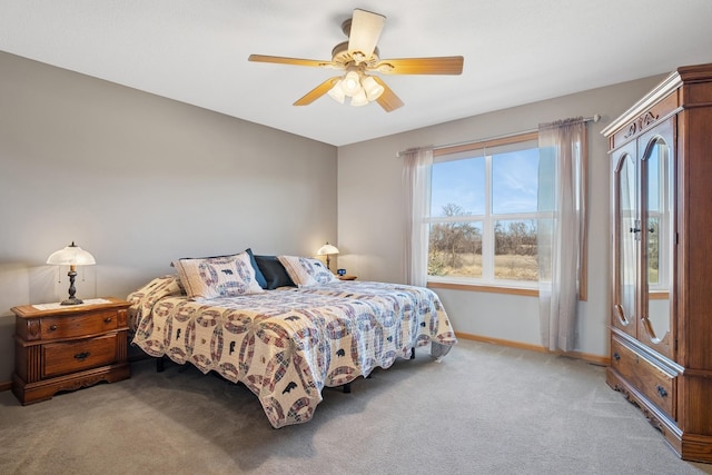 bedroom featuring baseboards, light colored carpet, and ceiling fan