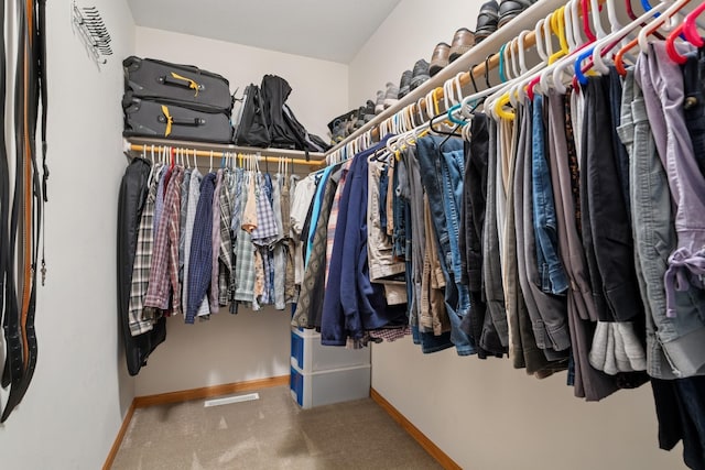 spacious closet with carpet flooring and visible vents