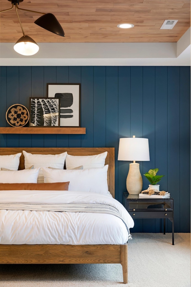 bedroom featuring wooden ceiling, visible vents, and carpet flooring