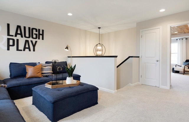 living room with light carpet, an inviting chandelier, baseboards, and recessed lighting