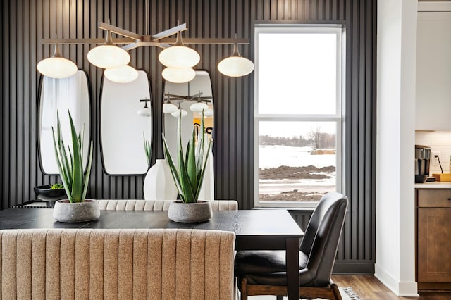 dining space featuring radiator, baseboards, and wood finished floors