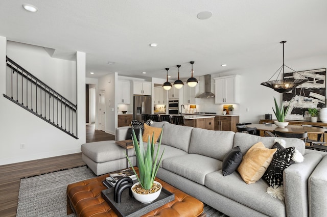 living room featuring dark wood-style flooring, stairway, recessed lighting, and baseboards