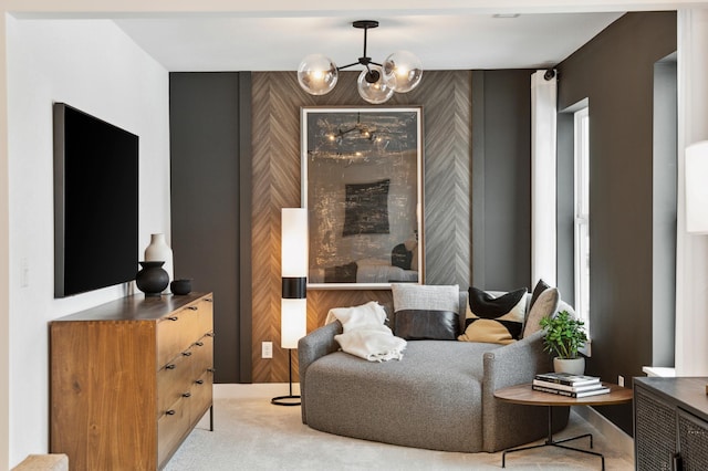 living area featuring a chandelier and carpet flooring