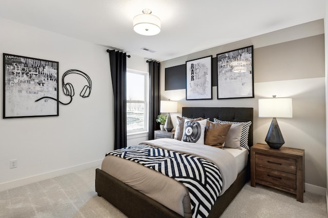 bedroom featuring baseboards, visible vents, and light colored carpet