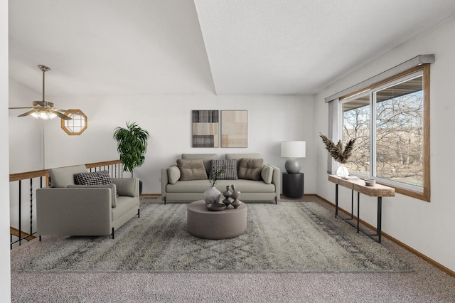 carpeted living area with a textured ceiling and baseboards