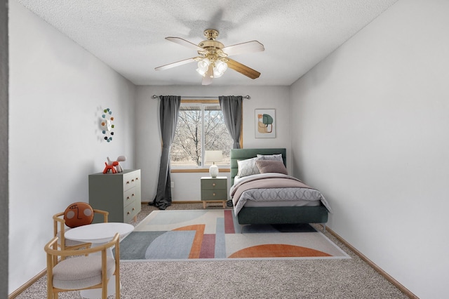 bedroom featuring a ceiling fan, carpet flooring, a textured ceiling, and baseboards