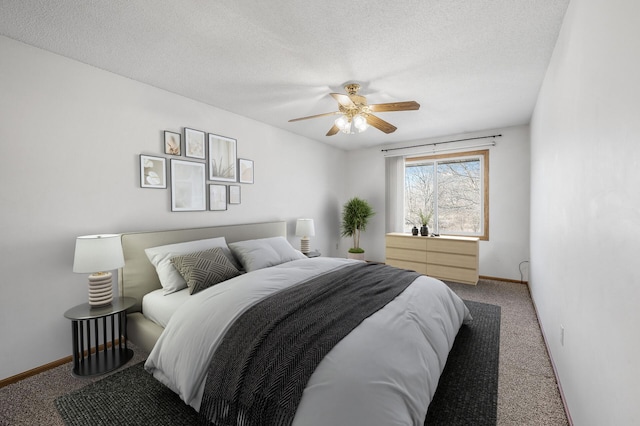 bedroom with a textured ceiling, carpet floors, ceiling fan, and baseboards