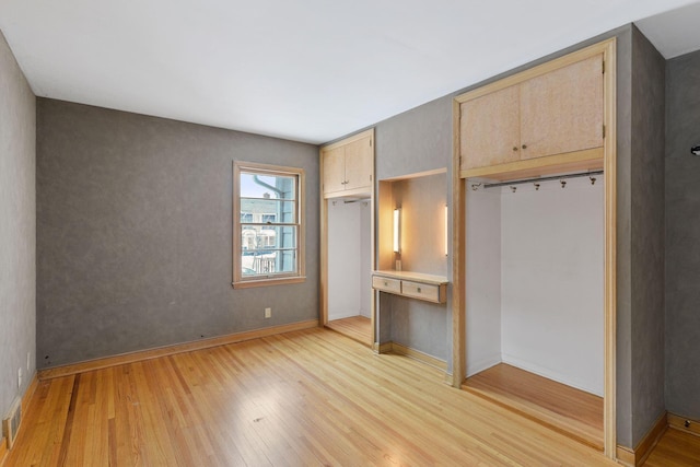 unfurnished bedroom featuring light wood-style flooring and baseboards