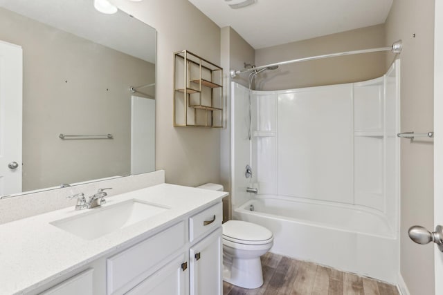 full bath featuring vanity, washtub / shower combination, toilet, and wood finished floors