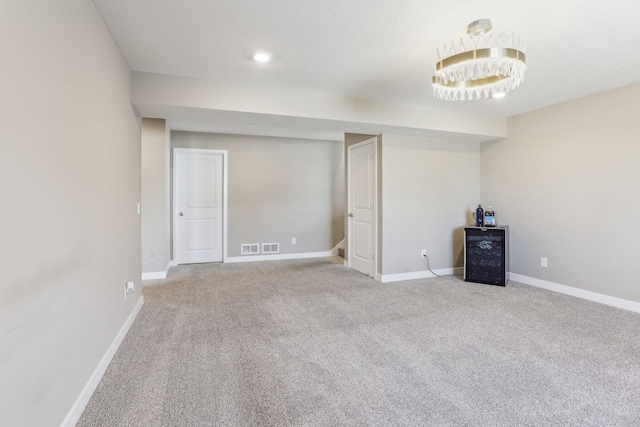 interior space featuring visible vents, baseboards, and carpet