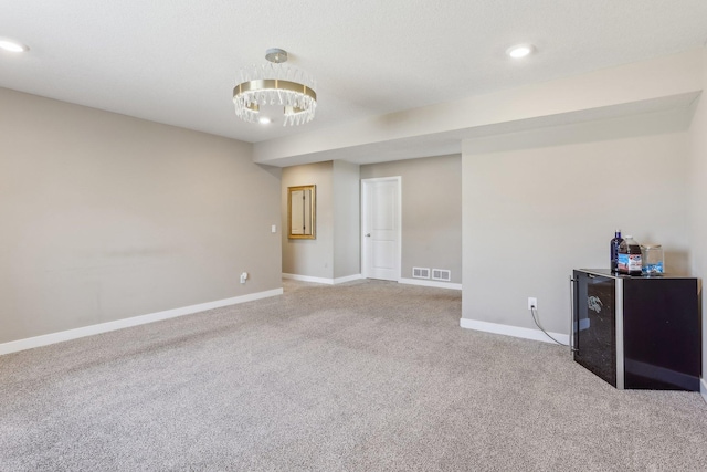 empty room featuring carpet flooring, recessed lighting, and baseboards