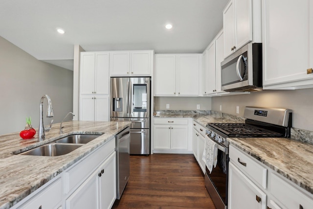 7295 Parson Ct NE, Otsego, MN 55330 - kitchen with appliances with stainless steel finishes, light stone counters, recessed lighting, and a sink