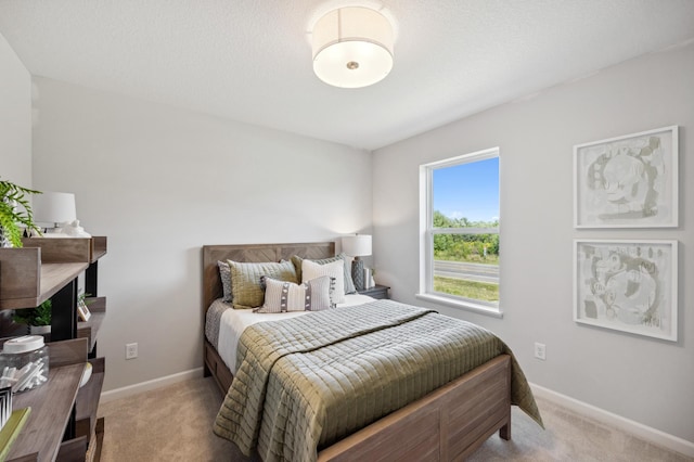 bedroom featuring a textured ceiling, carpet flooring, and baseboards