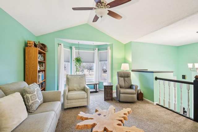 living area with carpet flooring, vaulted ceiling, baseboards, and ceiling fan