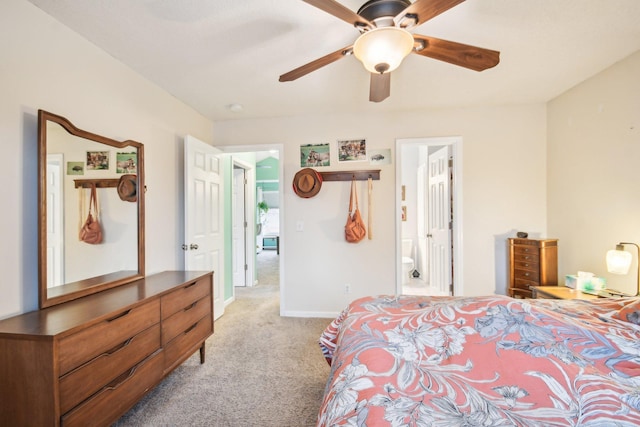 bedroom featuring baseboards, ceiling fan, ensuite bathroom, and light colored carpet