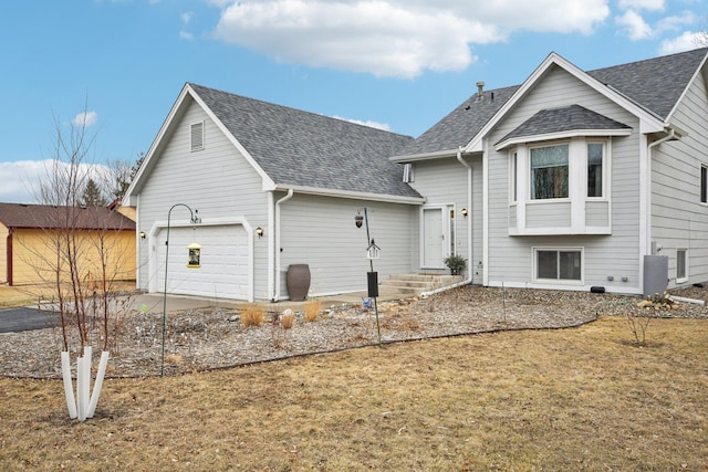 view of front of property with a garage, concrete driveway, and roof with shingles