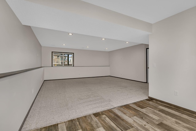 empty room with recessed lighting, baseboards, and wood finished floors