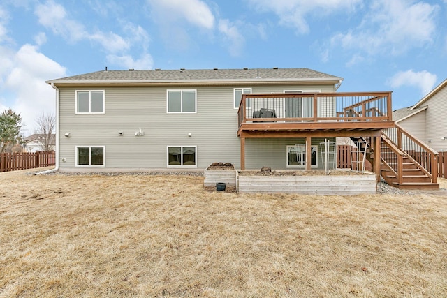 rear view of property with stairway, fence, and a deck