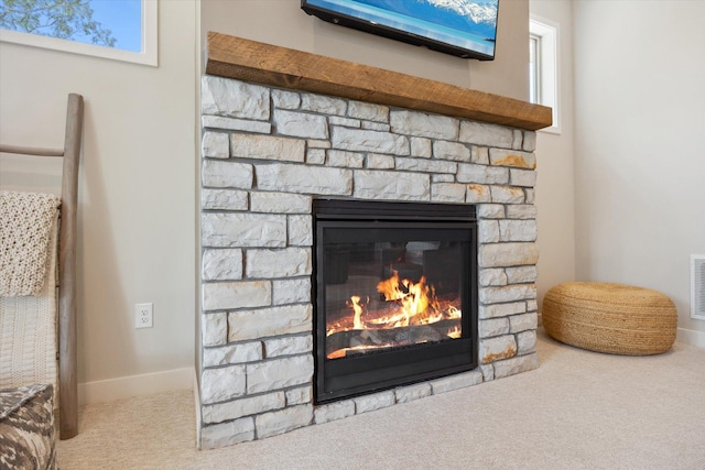 room details with carpet, baseboards, visible vents, and a fireplace