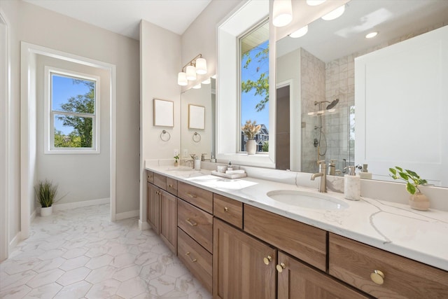 bathroom with double vanity, a stall shower, and a sink