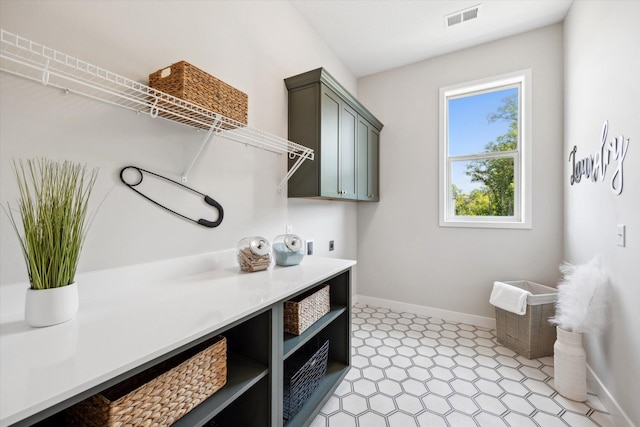 laundry room featuring hookup for an electric dryer, baseboards, visible vents, cabinet space, and light floors