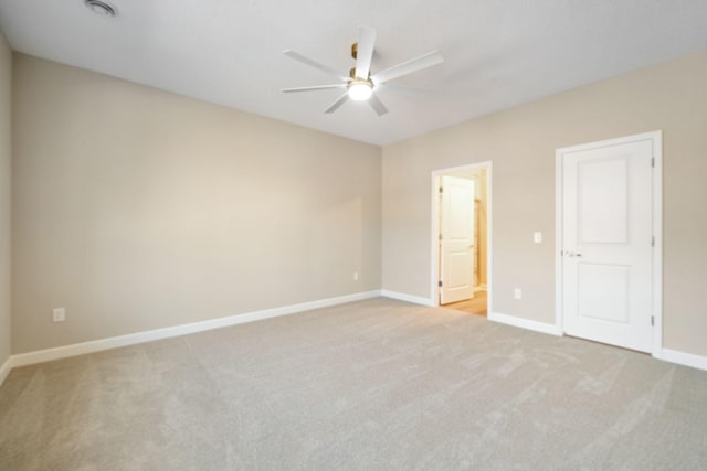 unfurnished bedroom with a ceiling fan, ensuite bath, baseboards, and carpet flooring