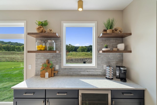 bar featuring wine cooler and backsplash