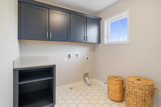 clothes washing area with washer hookup, cabinet space, electric dryer hookup, and baseboards