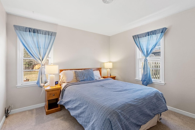 bedroom with carpet flooring and baseboards