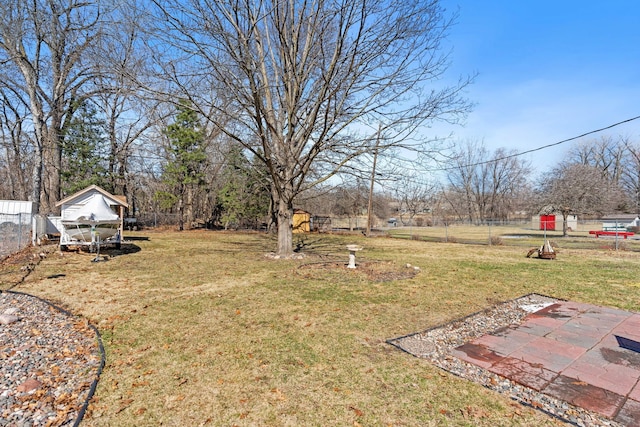 view of yard featuring an outdoor structure and fence