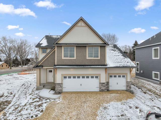 view of front of home featuring stone siding and driveway