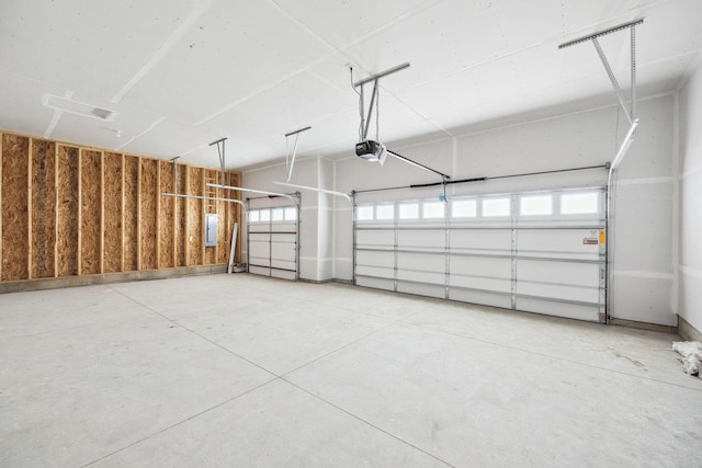 garage featuring electric panel and a garage door opener