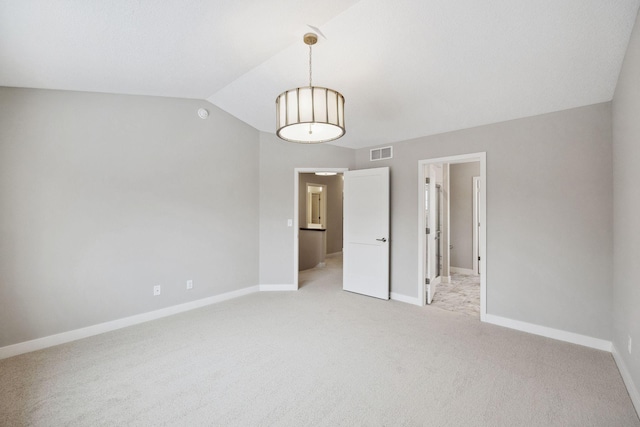 unfurnished bedroom featuring visible vents, vaulted ceiling, light carpet, and baseboards