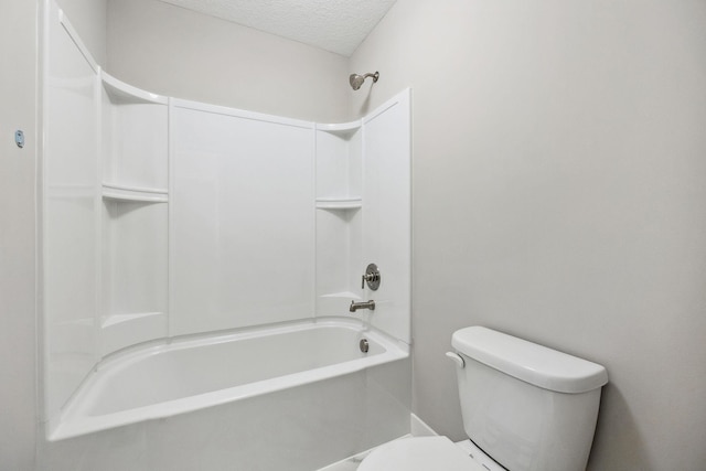 full bathroom featuring a textured ceiling and toilet