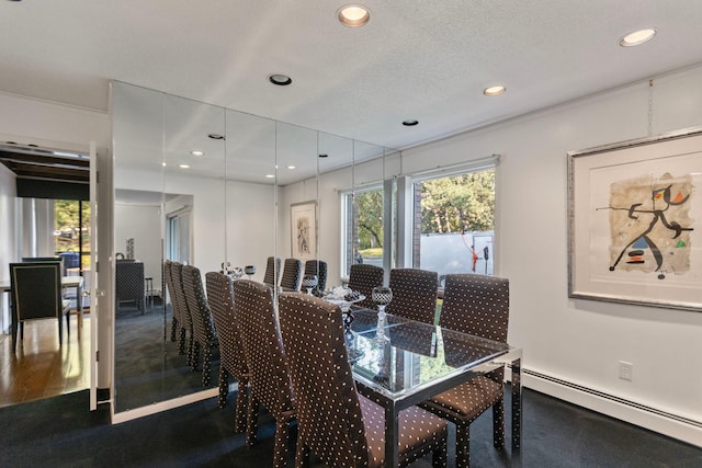 dining room featuring a baseboard heating unit, a textured ceiling, and recessed lighting