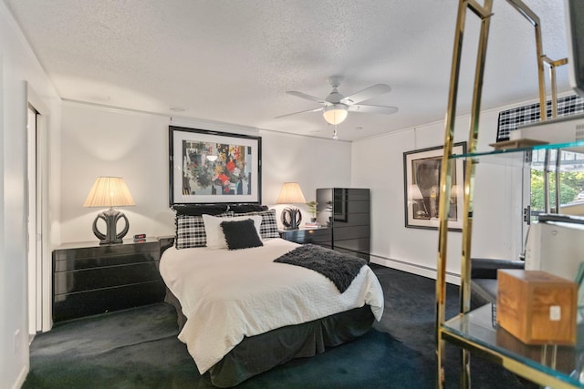 carpeted bedroom with a textured ceiling and a baseboard heating unit