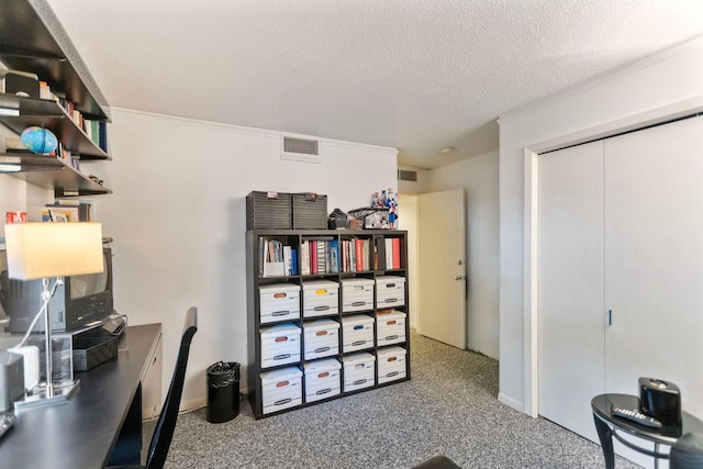 carpeted office featuring a textured ceiling, ornamental molding, and visible vents