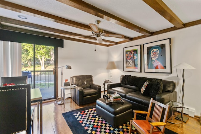 living area featuring ceiling fan, a baseboard radiator, wood finished floors, and beam ceiling