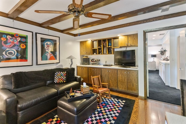 living room featuring a ceiling fan, beam ceiling, and wood finished floors