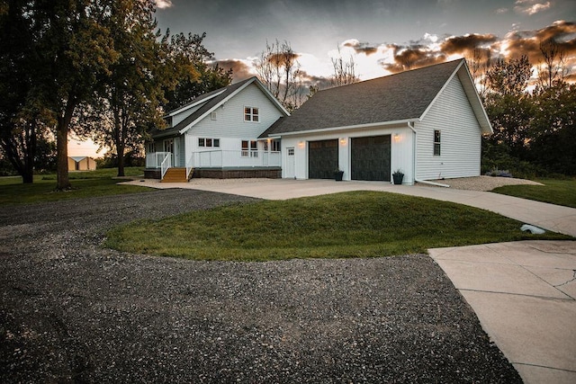 view of front facade with a garage, concrete driveway, and a front yard