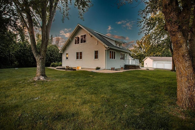 exterior space featuring an outbuilding, a yard, and a garage