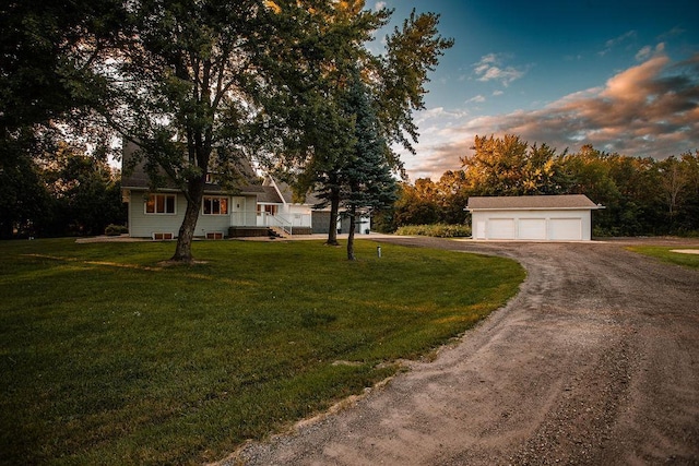 view of front of home with an outbuilding, a lawn, and a detached garage