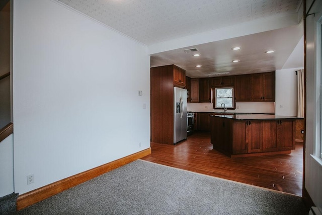 kitchen with baseboards, visible vents, recessed lighting, dark wood-type flooring, and appliances with stainless steel finishes