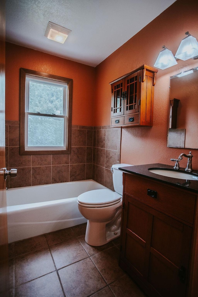 bathroom featuring a tub, toilet, and vanity