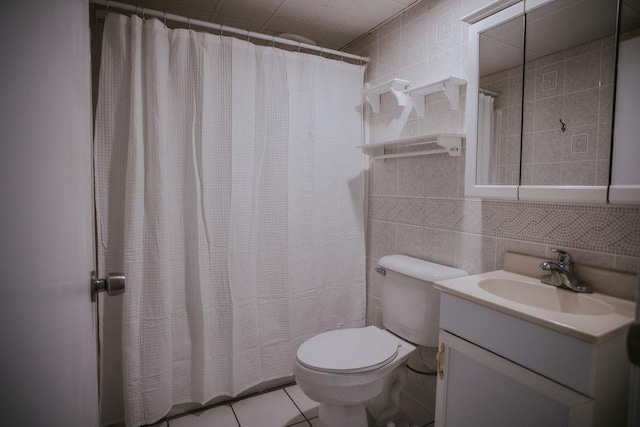 full bath with vanity, a shower with curtain, tile walls, toilet, and tile patterned floors